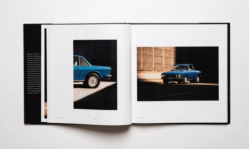Inside spread of the automotive photography book Waiting For The Sun To Come Down by Kevin McCauley, open to images of a blue Lancia Fulvia Coupe 3 with stunning shadows. Published by Carrara Media.