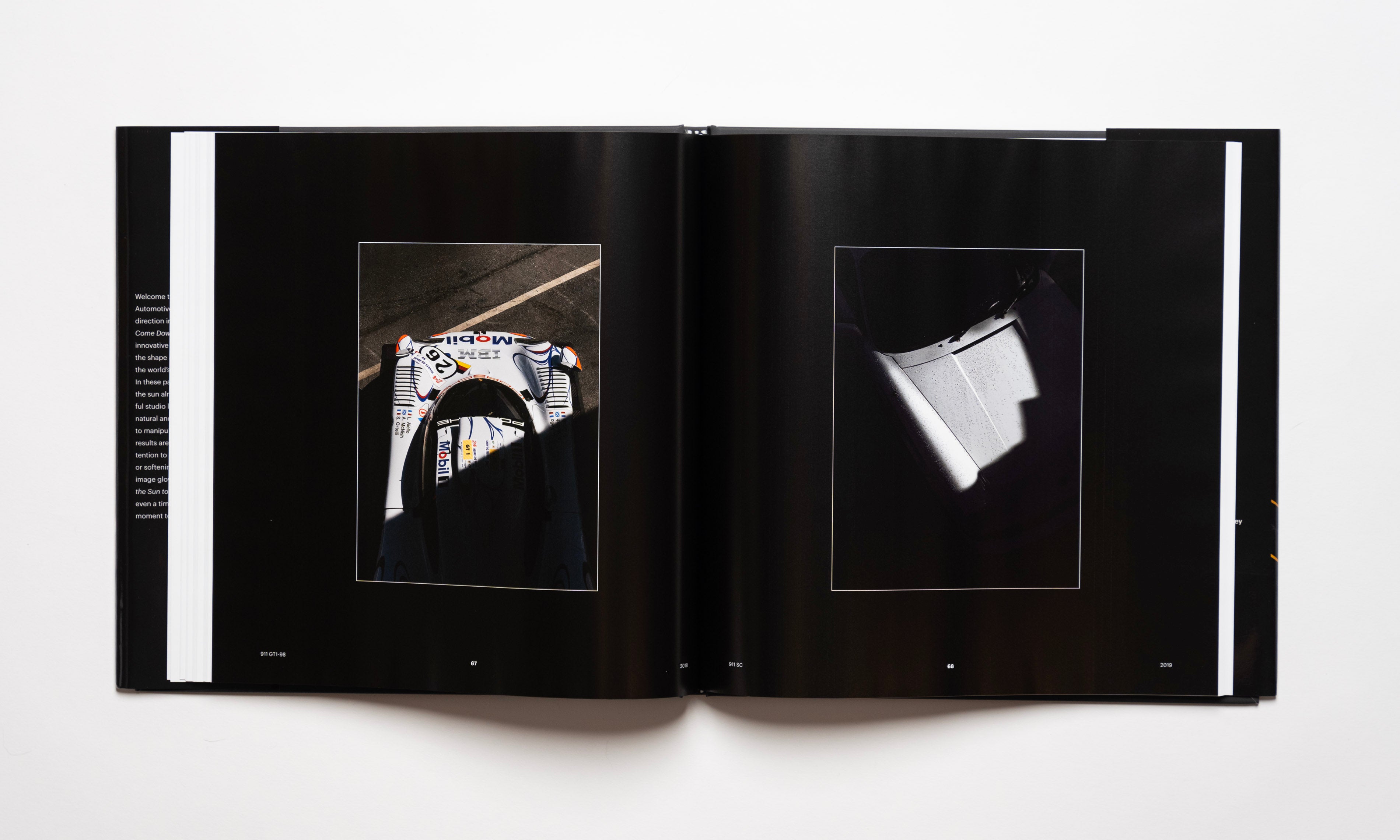Inside spread of the automotive photography book Waiting For The Sun To Come Down by Kevin McCauley, open to images of a Porsche 911 GT1 and a Porsche 911 SC with stunning shadows. Published by Carrara Media.