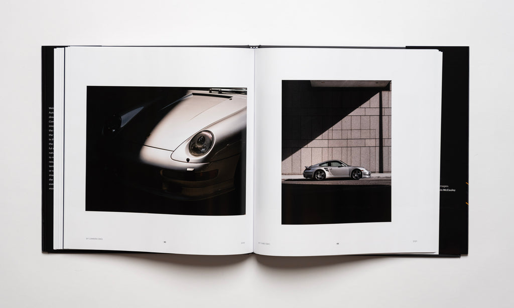 Inside spread of the automotive photography book Waiting For The Sun To Come Down by Kevin McCauley, open to images of a silver Porsche 911 Carrera 993 and Porsche 911 Turbo 997 with stunning shadows. Published by Carrara Media.