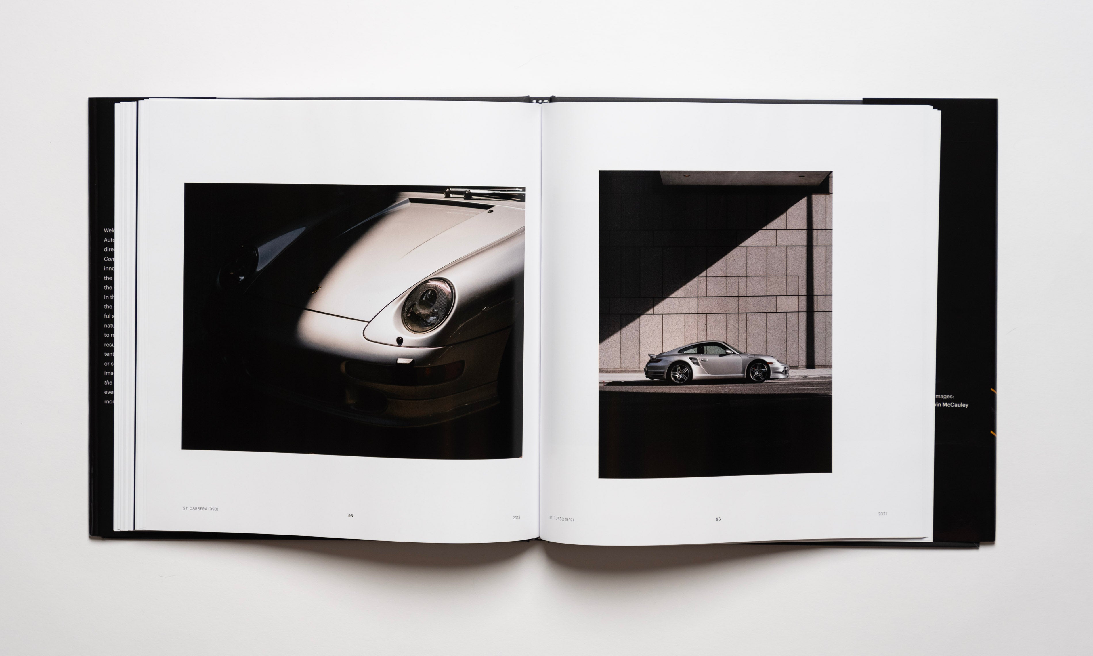 Inside spread of the automotive photography book Waiting For The Sun To Come Down by Kevin McCauley, open to images of a silver Porsche 911 Carrera 993 and Porsche 911 Turbo 997 with stunning shadows. Published by Carrara Media.