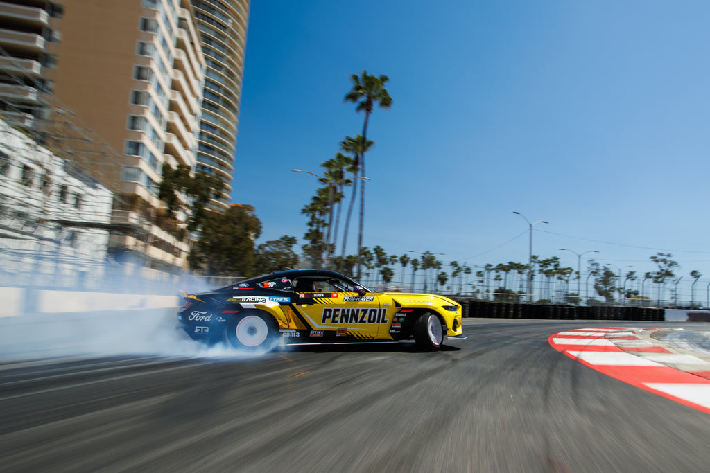 Image of Chelsea DeNofa driving Ford Mustang RTR FD in Formula Drift, photo by Larry Chen. From the 400-page coffee table book Life At Shutter Speed by Larry Chen, foreword by Jeff Zwart and afterword by Magnus Walker. Published by Carrara Media.