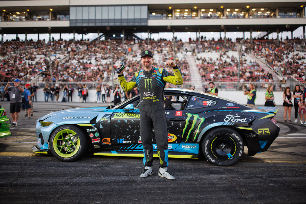 Image of Vaughn Gittin Jr. posing in front of his Ford Mustang RTR FD drift car during a Formula Drift event, photo by Larry Chen. From the new book Ready To Rock by Vaughn Gittin Jr. with Mike Spinelli, foreword by T-Pain, published by Carrara Media. The story of RTR Vehicles and professional drifting, off-road racing and the Ford RTR Mustang and RTR Bronco.