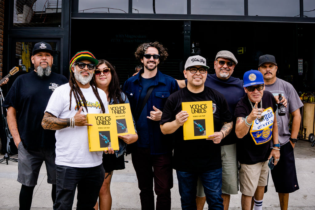 Volkswagen enthusiasts hold the new book Vochos Unidos by Rodrigo Gaya Villar, published by Carrara Media, at the release party in Los Angeles. A coffee table book of automotive photography showing the Volkswagen Beetle across Mexico, aka "El Vocho." Limited Edition with slipcase and Leen Customs pin available for 500 copies only.