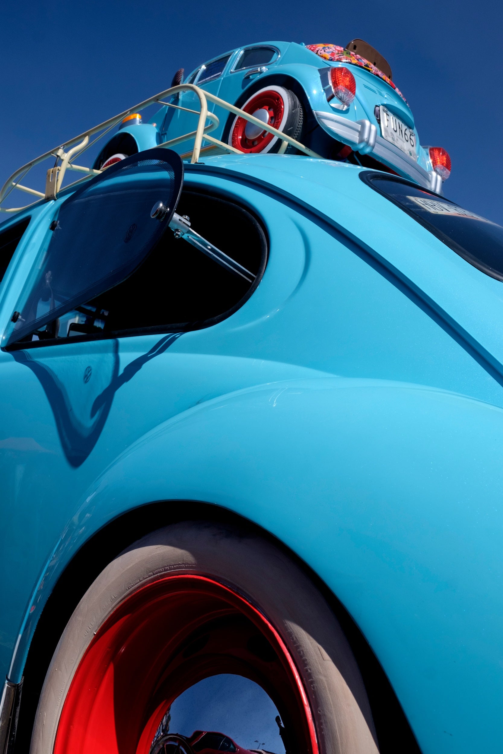 Image of a Volkswagen Beetle with a miniature car in matching blue strapped to the roof, from the new book Vochos Unidos by Rodrigo Gaya Villar, published by Carrara Media. A coffee table book of automotive photography showing the Volkswagen Beetle across Mexico, aka "El Vocho." Limited Edition with slipcase and Leen Customs pin available for 500 copies only.